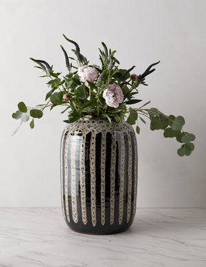 Wheaton full-bodied black and natural striped vase with flowers inside