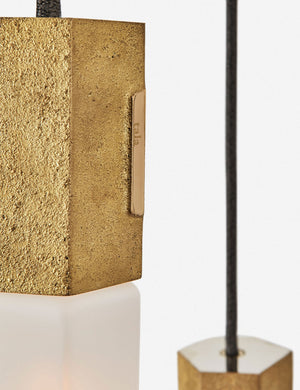 Close-up of the sand casted brass hardware on the Basalt slender hexagonal 3-light pendant light by tala