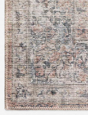 Close-up of the medallion patterns on the corner of the Roze blush and grey power-loomed rug