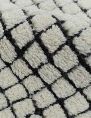 Close-up of the soft pile material on the Uma black and natural checkered grid pattern rug